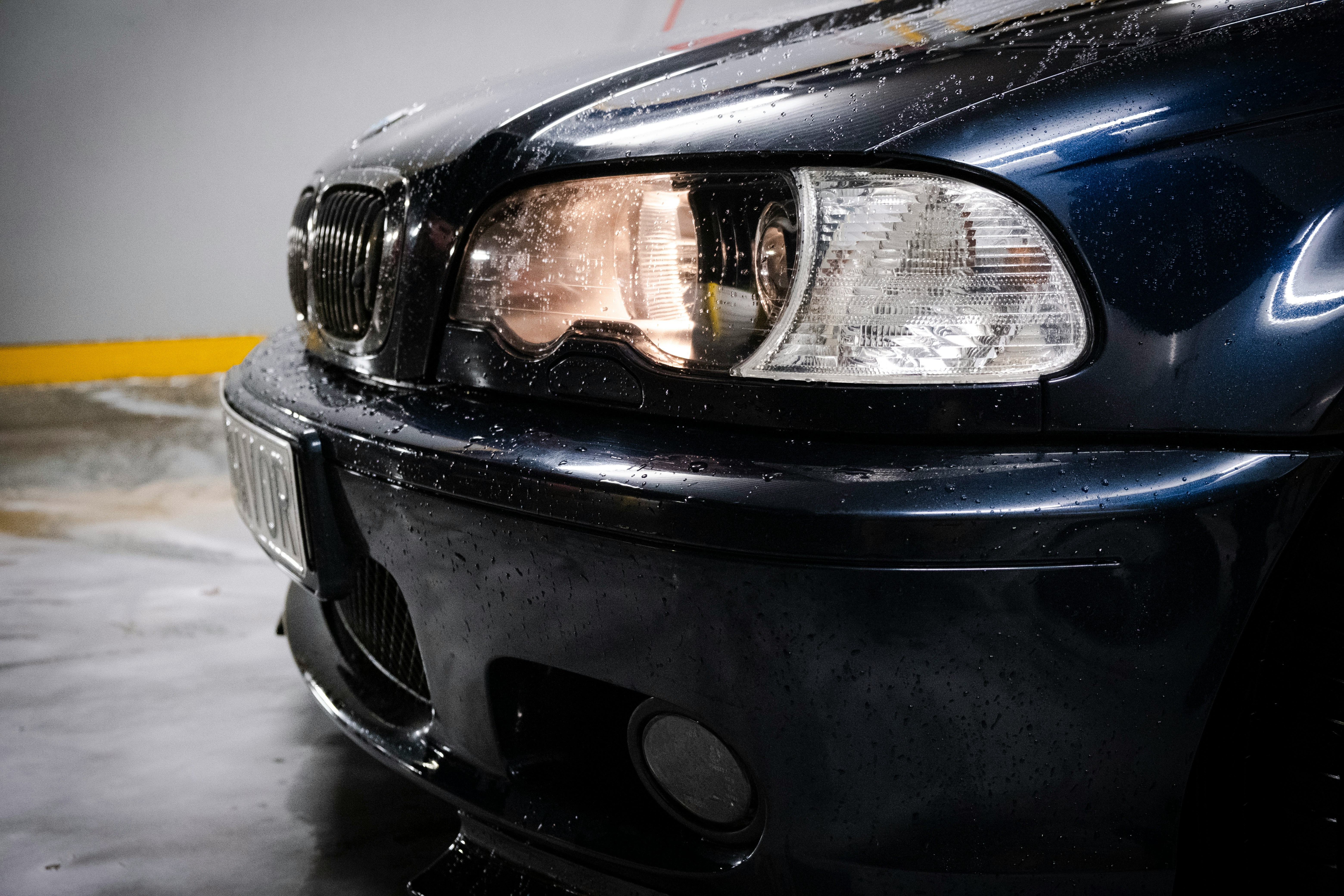 Close-up of water droplets on a freshly washed dark car after rain
