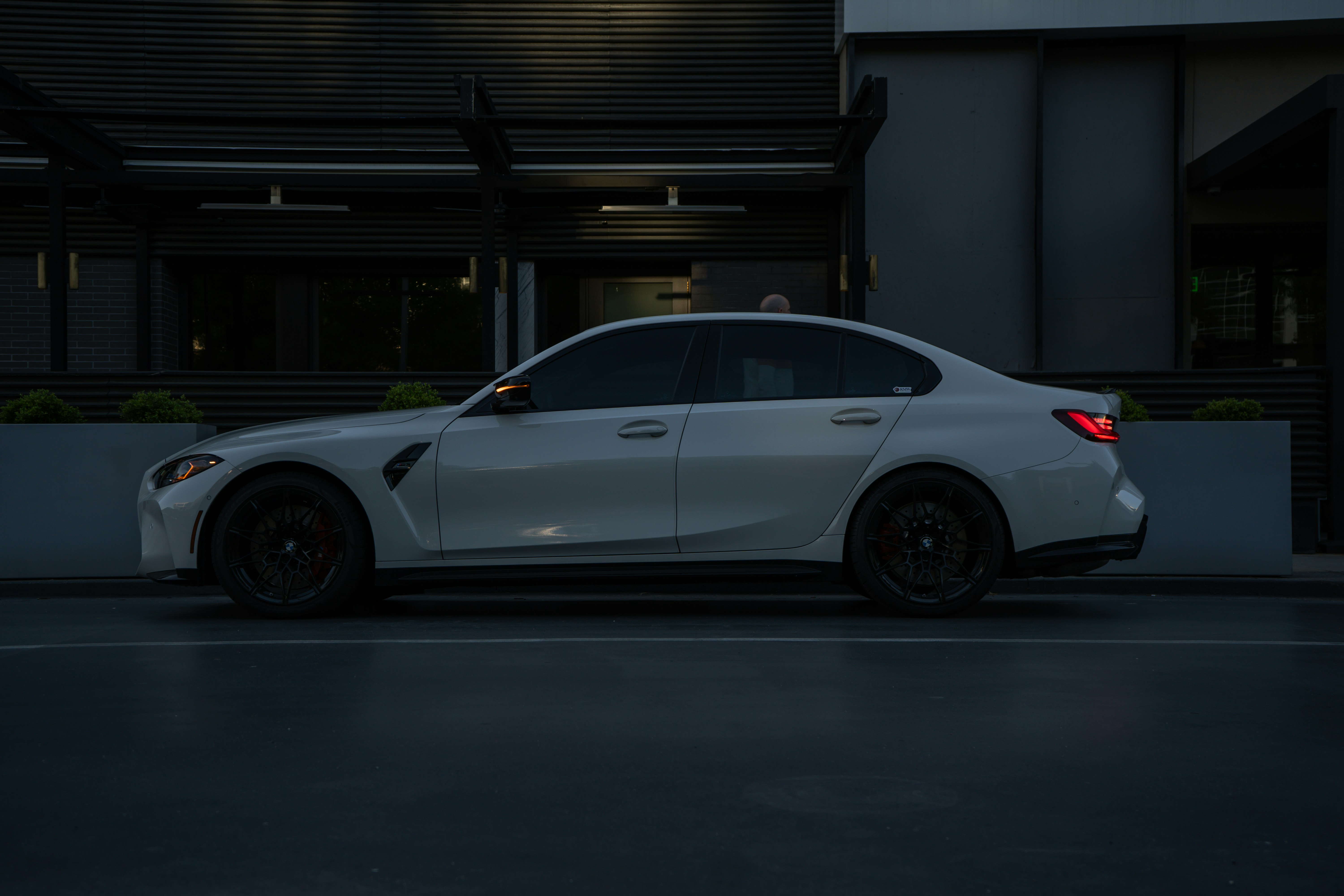 Freshly washed white sedan parked outside in the evening light